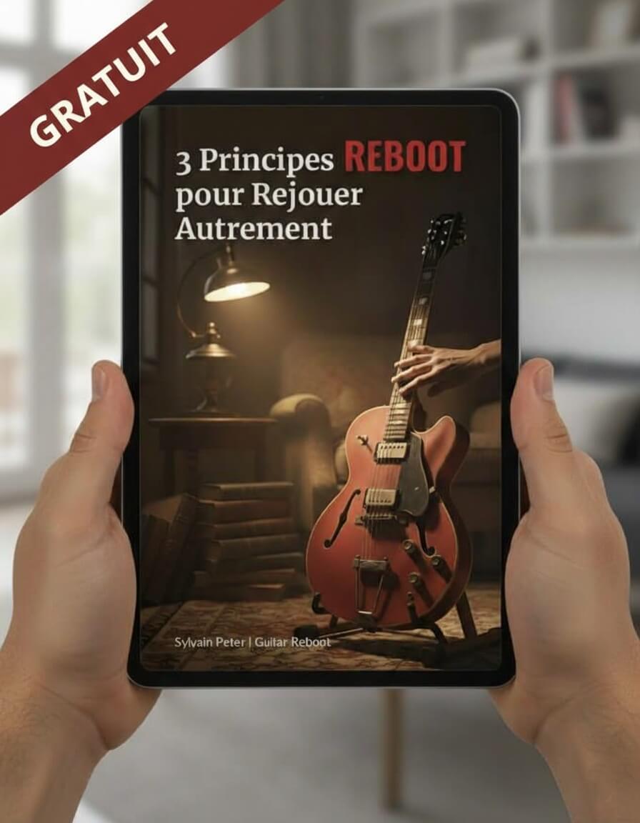 Couverture du guide gratuit de Guitar Reboot sur une tablette tenue par deux mains.